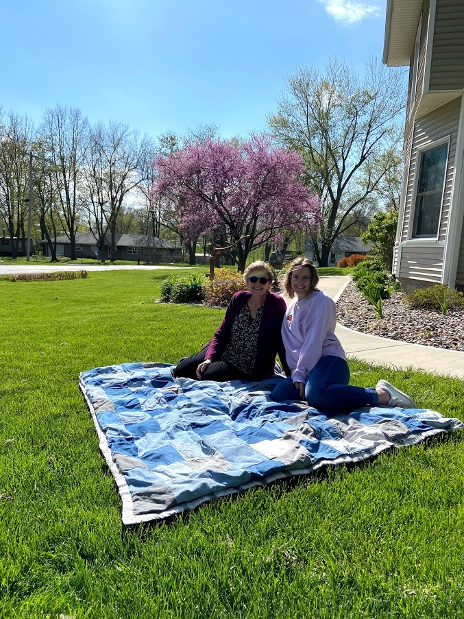 Jenny Doan and granddaughter Katie on a jean quilt. 